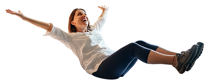 Woman falling onto a comfy bed